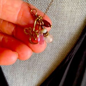 Om sign with gold tone 16” chain.